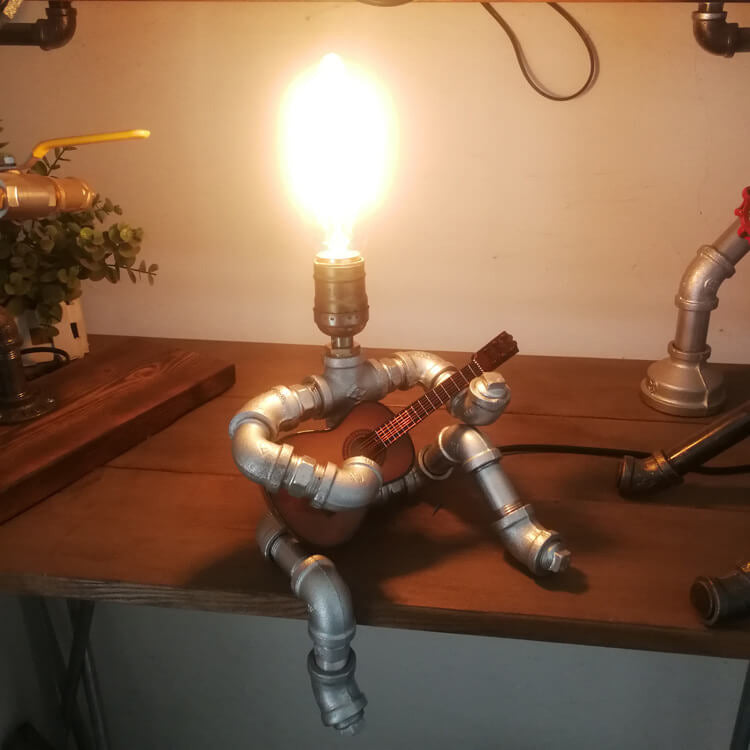 Industrial Plumbing Guitar Robot 1-Light Table Lamp | Unique LED Lighting | Modern Industrial Home Decor | Music-Themed Desk Lamp | Vintage Style Guitar Design | Creative Lighting Solution | Industrial Pipe Lamp | Adjustable Guitar Stand Base | Decorative