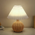 Contemporary Nordic Rattan Pleated LED Table Lamp for Bedroom 

Enhance your bedroom decor with this stylish contemporary Nordic rattan fabric table lamp. Featuring a unique pleated conic design, this LED lamp offers a warm, inviting glow while showcasing