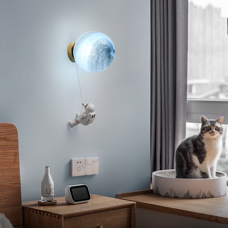 Contemporary Orb Astronaut Wall Sconce - Iron Resin 1-Light Lamp for Bedroom

Illuminate your space with the contemporary Orb Astronaut Wall Sconce, designed to bring a modern touch to your bedroom. This unique 1-light lamp features an elegant orb shape c