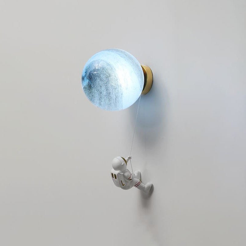 Contemporary Orb Astronaut Wall Sconce - Iron Resin 1-Light Lamp for Bedroom

Illuminate your space with the contemporary Orb Astronaut Wall Sconce, designed to bring a modern touch to your bedroom. This unique 1-light lamp features an elegant orb shape c