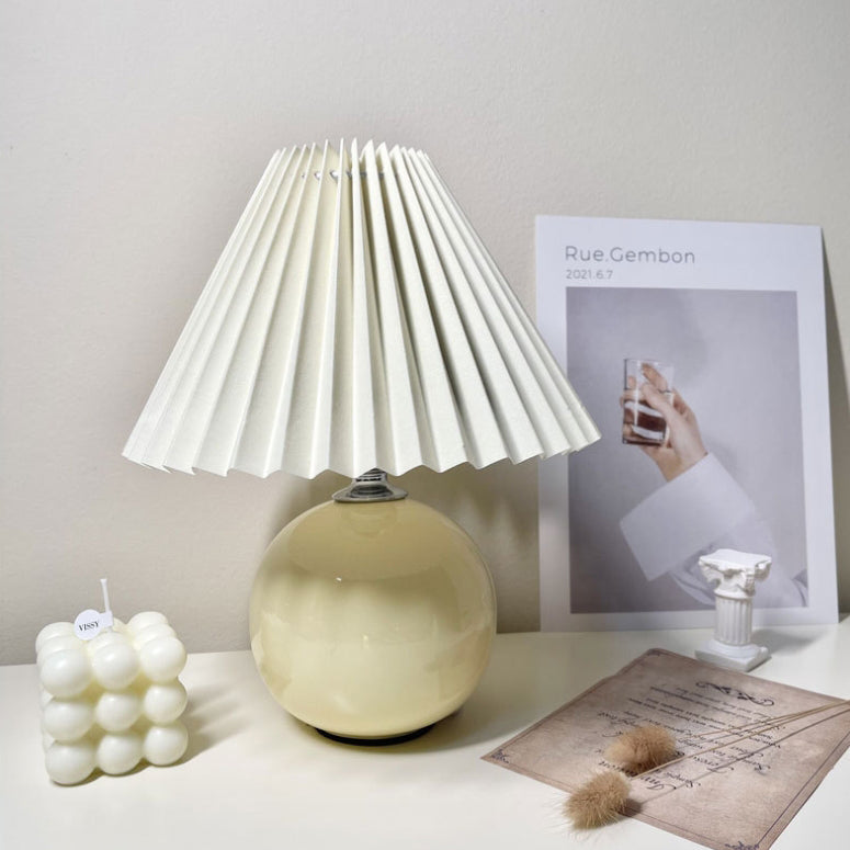 Modern Minimalist Round Fabric Pleated Ceramic 1-Light Table Lamp for Bedroom | Stylish Bedside Lighting | Contemporary Home Decor | Elegant Bedroom Accent | Soft Ambient Illumination | Decorative Lighting Fixture | Chic Fabric Shade | Ceramic Base Design