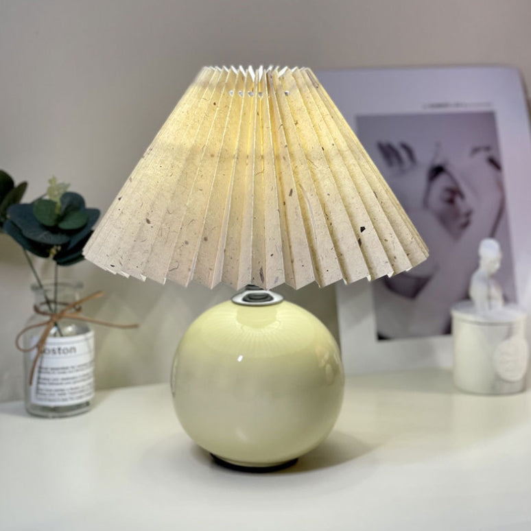 Modern Minimalist Round Fabric Pleated Ceramic 1-Light Table Lamp for Bedroom | Stylish Bedside Lighting | Contemporary Home Decor | Elegant Bedroom Accent | Soft Ambient Illumination | Decorative Lighting Fixture | Chic Fabric Shade | Ceramic Base Design