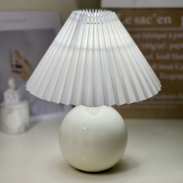 Modern Minimalist Round Fabric Pleated Ceramic 1-Light Table Lamp for Bedroom | Stylish Bedside Lighting | Contemporary Home Decor | Elegant Bedroom Accent | Soft Ambient Illumination | Decorative Lighting Fixture | Chic Fabric Shade | Ceramic Base Design