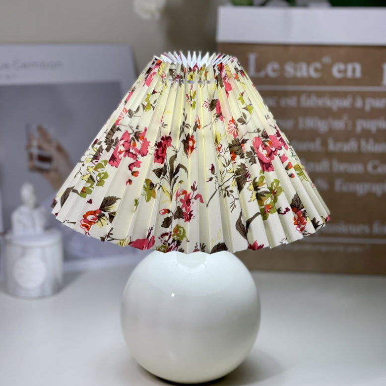 Modern Minimalist Round Fabric Pleated Ceramic 1-Light Table Lamp for Bedroom | Stylish Bedside Lighting | Contemporary Home Decor | Elegant Bedroom Accent | Soft Ambient Illumination | Decorative Lighting Fixture | Chic Fabric Shade | Ceramic Base Design
