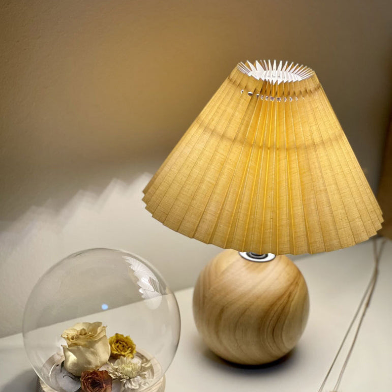 Modern Minimalist Round Fabric Pleated Ceramic 1-Light Table Lamp for Bedroom | Stylish Bedside Lighting | Contemporary Home Decor | Elegant Bedroom Accent | Soft Ambient Illumination | Decorative Lighting Fixture | Chic Fabric Shade | Ceramic Base Design