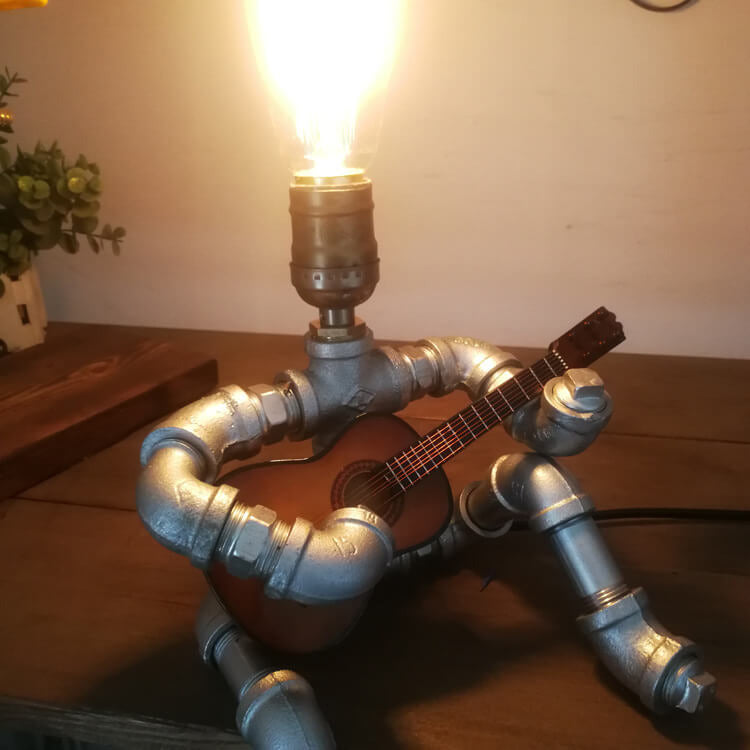 Industrial Plumbing Guitar Robot 1-Light Table Lamp | Unique LED Lighting | Modern Industrial Home Decor | Music-Themed Desk Lamp | Vintage Style Guitar Design | Creative Lighting Solution | Industrial Pipe Lamp | Adjustable Guitar Stand Base | Decorative