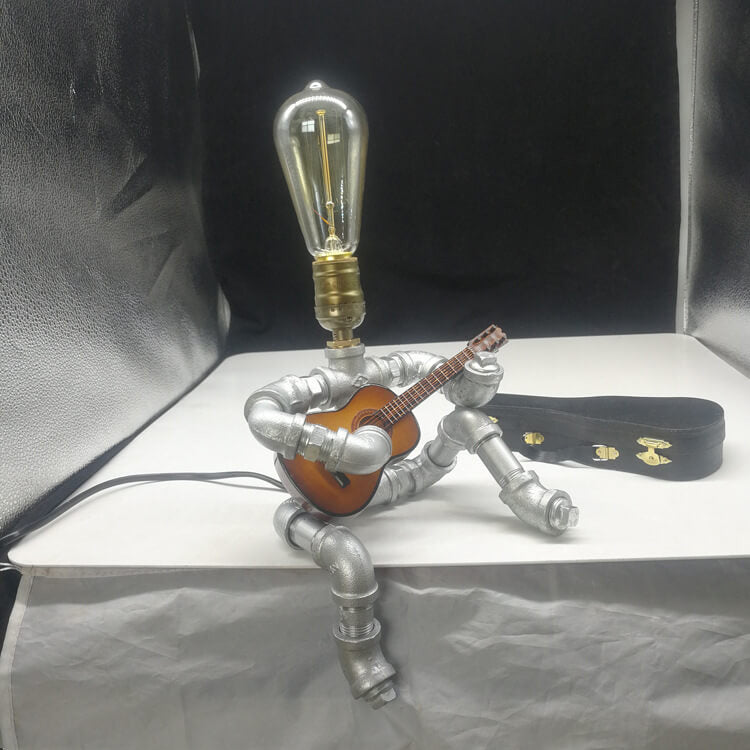 Industrial Plumbing Guitar Robot 1-Light Table Lamp | Unique LED Lighting | Modern Industrial Home Decor | Music-Themed Desk Lamp | Vintage Style Guitar Design | Creative Lighting Solution | Industrial Pipe Lamp | Adjustable Guitar Stand Base | Decorative