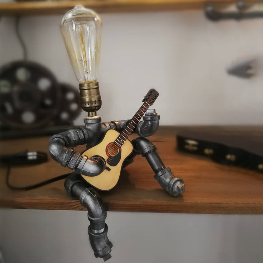 Industrial Plumbing Guitar Robot 1-Light Table Lamp | Unique LED Lighting | Modern Industrial Home Decor | Music-Themed Desk Lamp | Vintage Style Guitar Design | Creative Lighting Solution | Industrial Pipe Lamp | Adjustable Guitar Stand Base | Decorative