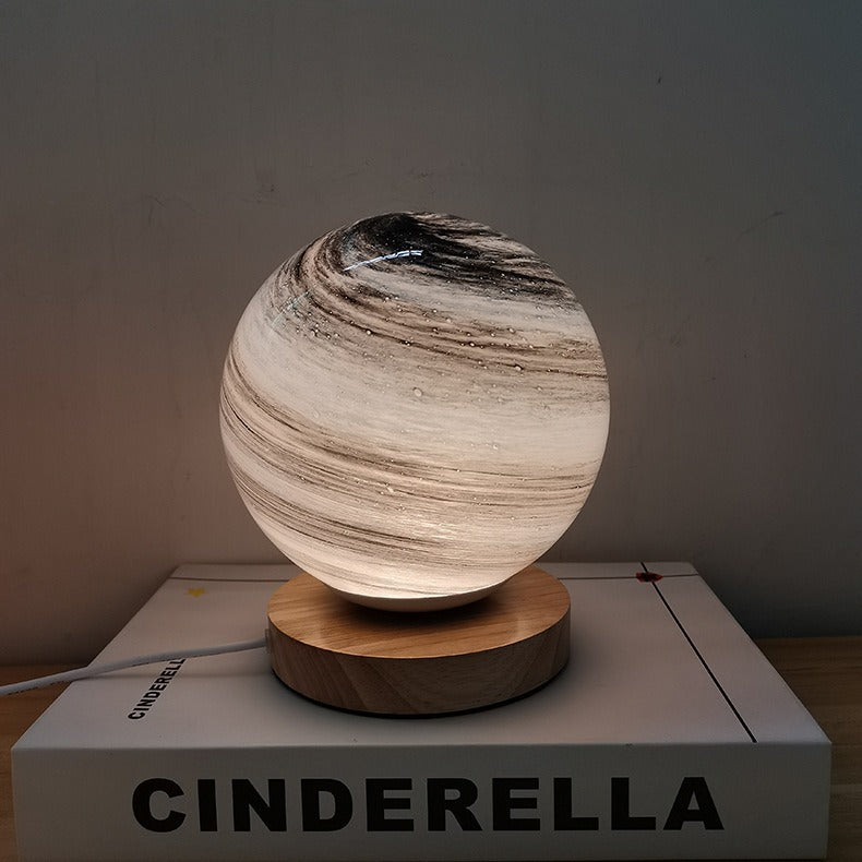 Contemporary Globe Wood Glass LED Table Lamp for Living Room  

Illuminate your living space with our stylish Contemporary Globe Wood Glass LED Table Lamp. This modern design features a chic globe shape, combining natural wood and sleek glass for a perfec