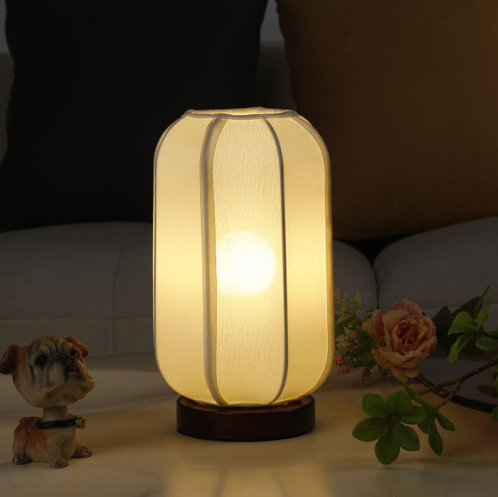 Traditional Chinese Fabric Cylinder Shade Table Lamp - 1-Light Wood Base for Bedroom 

Illuminate your space with this elegant Traditional Chinese table lamp. Featuring a unique fabric cylinder shade, it adds a touch of cultural charm to any bedroom. The
