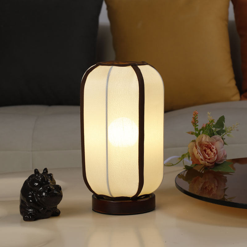 Traditional Chinese Fabric Cylinder Shade Table Lamp - 1-Light Wood Base for Bedroom 

Illuminate your space with this elegant Traditional Chinese table lamp. Featuring a unique fabric cylinder shade, it adds a touch of cultural charm to any bedroom. The