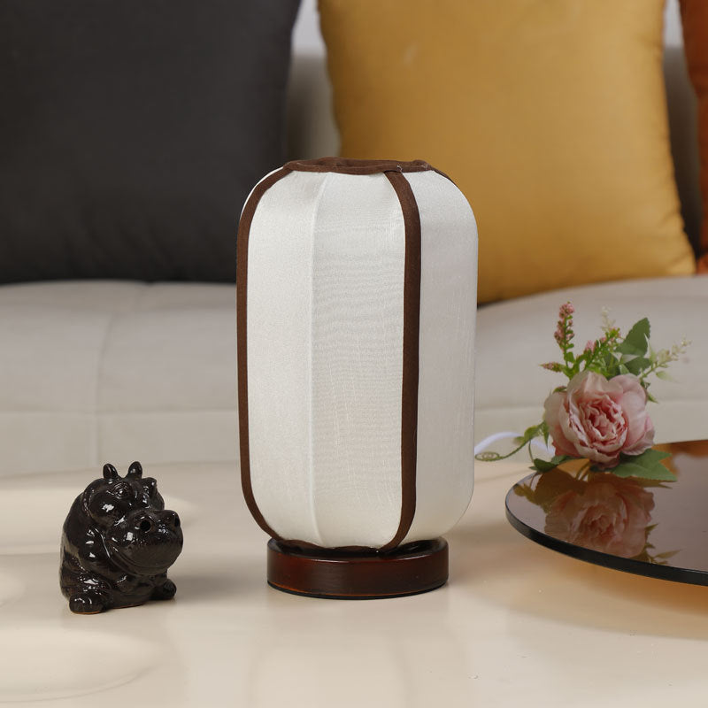 Traditional Chinese Fabric Cylinder Shade Table Lamp - 1-Light Wood Base for Bedroom 

Illuminate your space with this elegant Traditional Chinese table lamp. Featuring a unique fabric cylinder shade, it adds a touch of cultural charm to any bedroom. The