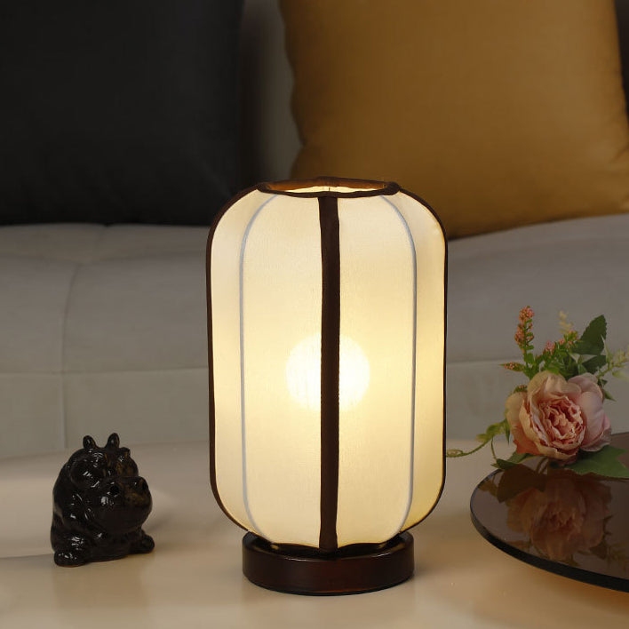 Traditional Chinese Fabric Cylinder Shade Table Lamp - 1-Light Wood Base for Bedroom 

Illuminate your space with this elegant Traditional Chinese table lamp. Featuring a unique fabric cylinder shade, it adds a touch of cultural charm to any bedroom. The