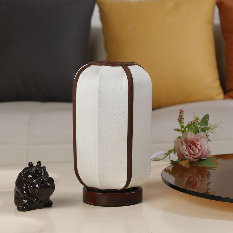 Traditional Chinese Fabric Cylinder Shade Table Lamp - 1-Light Wood Base for Bedroom 

Illuminate your space with this elegant Traditional Chinese table lamp. Featuring a unique fabric cylinder shade, it adds a touch of cultural charm to any bedroom. The