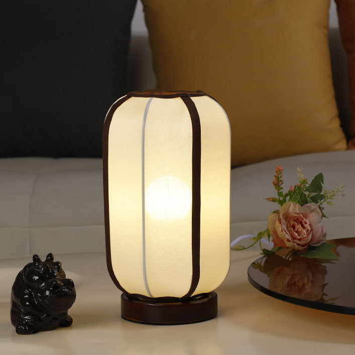 Traditional Chinese Fabric Cylinder Shade Table Lamp - 1-Light Wood Base for Bedroom 

Illuminate your space with this elegant Traditional Chinese table lamp. Featuring a unique fabric cylinder shade, it adds a touch of cultural charm to any bedroom. The