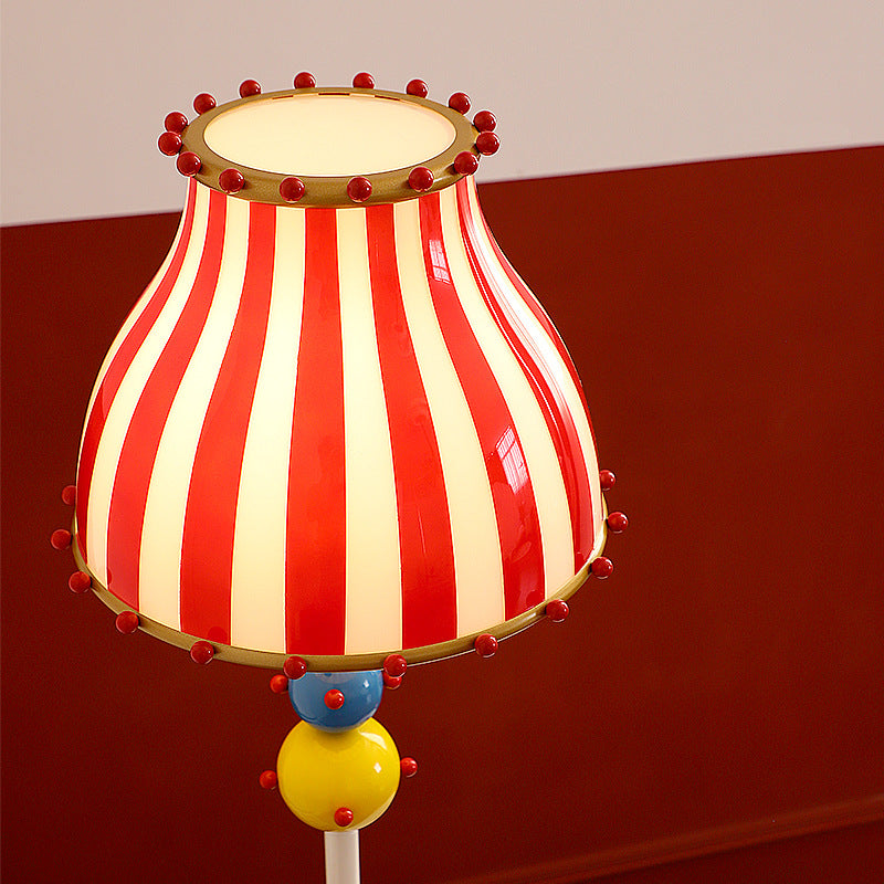 Contemporary Circus Red & White Striped Glass Round Shade Floor Lamp - 1-Light Iron Design for Bedroom  

Illuminate your bedroom with this stylish contemporary floor lamp featuring a unique circus-inspired design. The vibrant red and white striped glass
