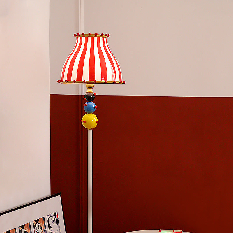 Contemporary Circus Red & White Striped Glass Round Shade Floor Lamp - 1-Light Iron Design for Bedroom  

Illuminate your bedroom with this stylish contemporary floor lamp featuring a unique circus-inspired design. The vibrant red and white striped glass