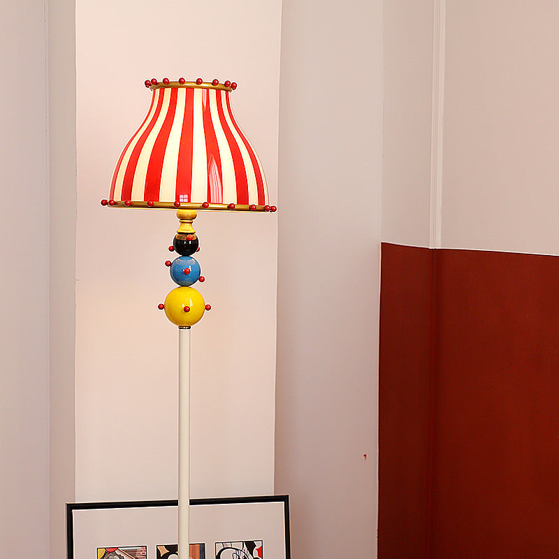 Contemporary Circus Red & White Striped Glass Round Shade Floor Lamp - 1-Light Iron Design for Bedroom  

Illuminate your bedroom with this stylish contemporary floor lamp featuring a unique circus-inspired design. The vibrant red and white striped glass