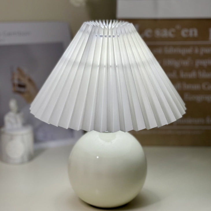Modern Minimalist Round Fabric Pleated Ceramic 1-Light Table Lamp for Bedroom | Stylish Bedside Lighting | Contemporary Home Decor | Elegant Bedroom Accent | Soft Ambient Illumination | Decorative Lighting Fixture | Chic Fabric Shade | Ceramic Base Design