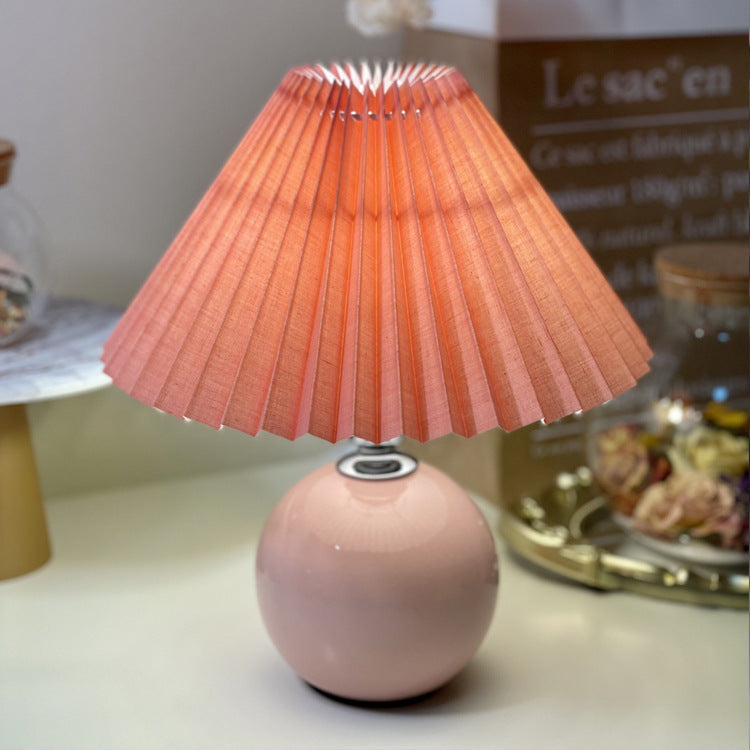 Modern Minimalist Round Fabric Pleated Ceramic 1-Light Table Lamp for Bedroom | Stylish Bedside Lighting | Contemporary Home Decor | Elegant Bedroom Accent | Soft Ambient Illumination | Decorative Lighting Fixture | Chic Fabric Shade | Ceramic Base Design