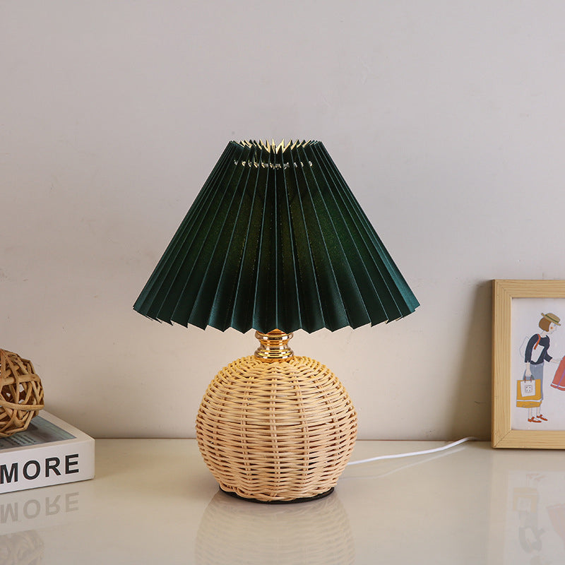 Contemporary Nordic Rattan Pleated LED Table Lamp for Bedroom 

Enhance your bedroom decor with this stylish contemporary Nordic rattan fabric table lamp. Featuring a unique pleated conic design, this LED lamp offers a warm, inviting glow while showcasing