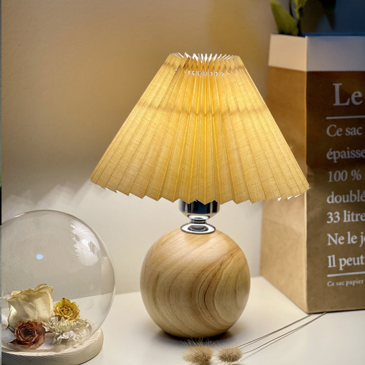 Modern Minimalist Round Fabric Pleated Ceramic 1-Light Table Lamp for Bedroom | Stylish Bedside Lighting | Contemporary Home Decor | Elegant Bedroom Accent | Soft Ambient Illumination | Decorative Lighting Fixture | Chic Fabric Shade | Ceramic Base Design