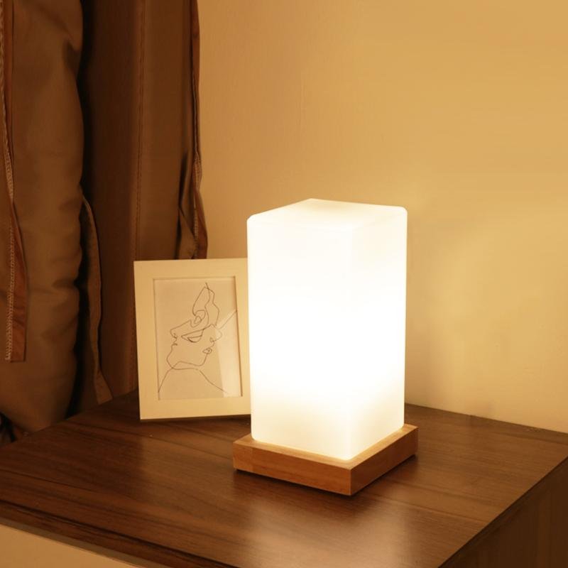 Title: Battery-Powered LED Wooden Cube Lamp

Description: Illuminate your space with our stylish Square Table Light. This Battery-Powered LED Wooden Cube Lamp combines modern design with warm ambiance, making it perfect for any room. Ideal for nightstands