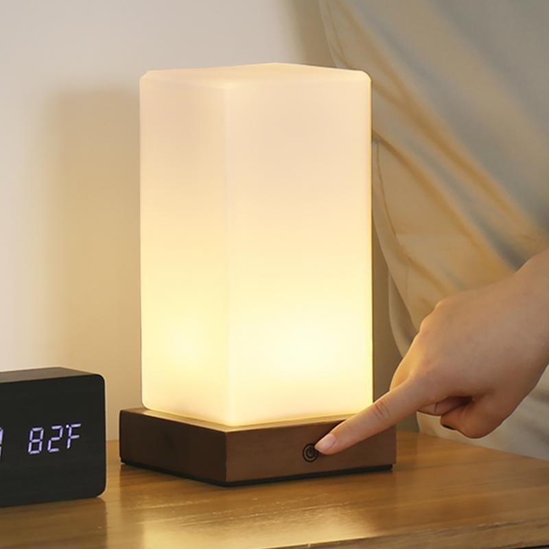 Title: Battery-Powered LED Wooden Cube Lamp

Description: Illuminate your space with our stylish Square Table Light. This Battery-Powered LED Wooden Cube Lamp combines modern design with warm ambiance, making it perfect for any room. Ideal for nightstands